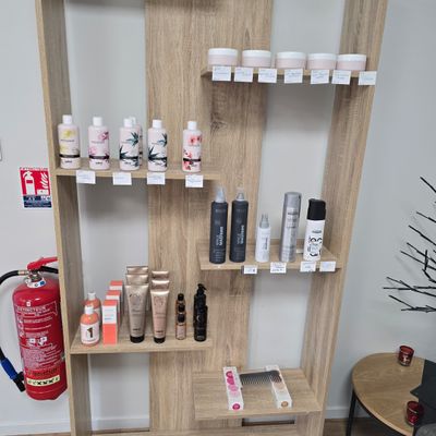 a shelf that has many different types of hair products on it