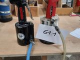 a picture of a drill and a hose on a workbench