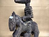 statue of a man riding a horse with a dog on its back