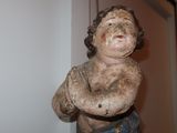 a small statue of a man with his arms crossed