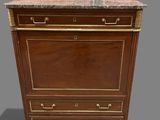 an antique chest of drawers with a marble top