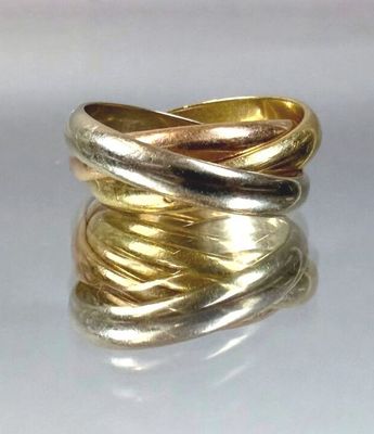 two gold rings stacked on top of each other on a white surface