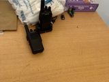 a table with a radio, a bag of diapers, and a pair of walkie talkies on it