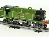 a green train on the tracks on a white background