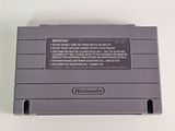 an old nintendo game console sitting on top of a white table