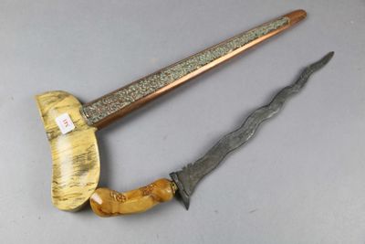 pair of antique wooden and metal knifes on a gray surface