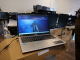 a laptop computer sitting on top of a box in a room