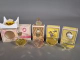 several small bottles of perfume sitting next to each other on a table