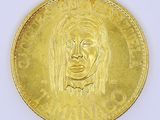 an image of a gold coin with a woman ' s face on it