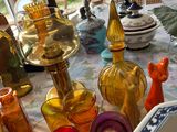many different colored glass vases on the table