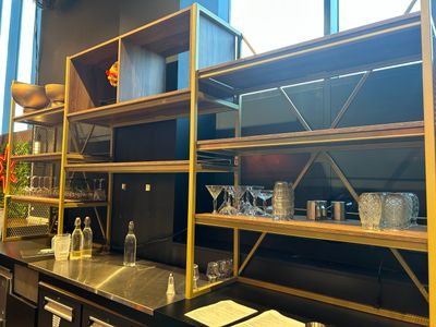 a bar with a lot of bottles and glasses on it