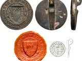 an image of a group of metal objects including a seal, a stamp, and a knife