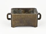 brass planter with handles on a white background