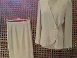 a white suit and a white skirt on a mannequin stand