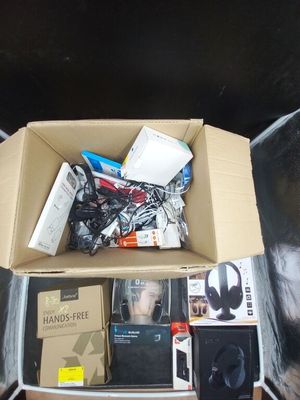 a cardboard box full of electronic equipment on the floor