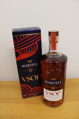 the bottle is next to the box on the table
