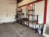 a room with a bunch of shelves and a sink