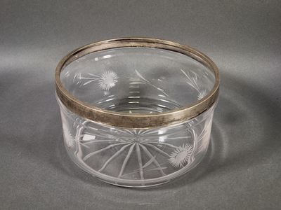 a glass container with a gold rim on a table