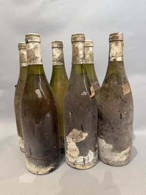four bottles of wine are lined up in a row on a table