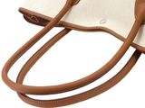 a close up of a bag on a white background with a brown handle