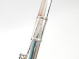 a silver and gold flute that is sitting on a table