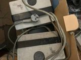 a pile of electronic devices sitting on top of a cardboard box