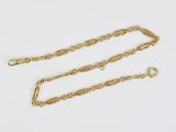 a pair of gold chain bracelets on a white background