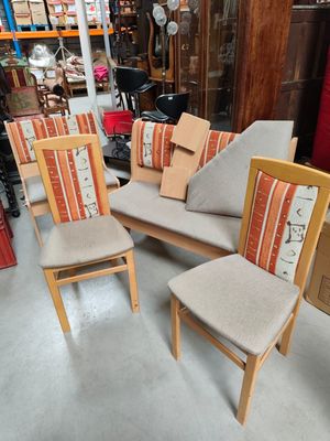 three chairs with cushions and a chair with a cushion on them