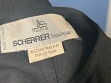 the label on the shirt says, ' scherrer boutique, scherrer boutique, scherrer boutique '