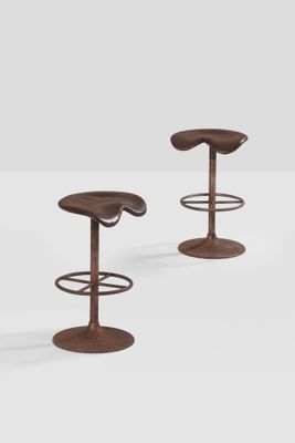 a pair of stools made of metal and wood