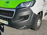 a green and white van parked in a parking lot