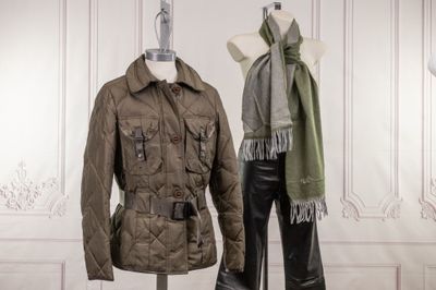 pair of women ' s jackets and pants on mannequins in a white room