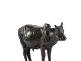a statue of a cow that is standing on a base