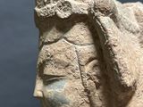 statue of a woman wearing a headdress with her eyes closed