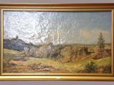 an oil painting of a landscape in a gold frame on a wall