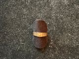 a ring that is on top of a piece of wood