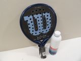 a tennis racquet and a bottle of water on a table