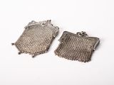 a pair of antique silver mesh purses on a white background