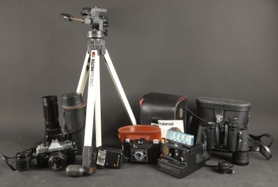a tripod with a camera and other items on a table