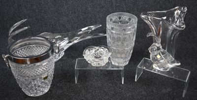 three glass vases and a candle holder sitting on a table