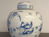 un vase bleu et blanc orné d'un singe