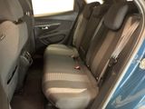 the back seats of a blue car with a black seat belt