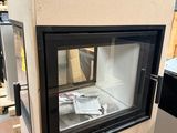a small oven sitting in the middle of a room