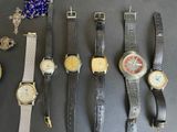 a lot of watches that are sitting on a table