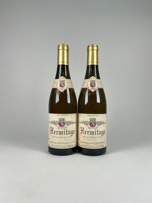two bottles of wine sitting next to each other on a table