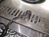 an image of a stainless steel stove top on a tiled floor