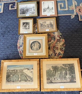 many framed pictures on the floor of this room