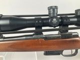 a close up of a rifle with a scope on it