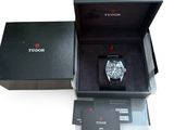 a box with a watch inside of it on a white surface