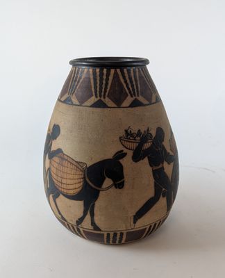 a vase with a picture of a man riding a horse